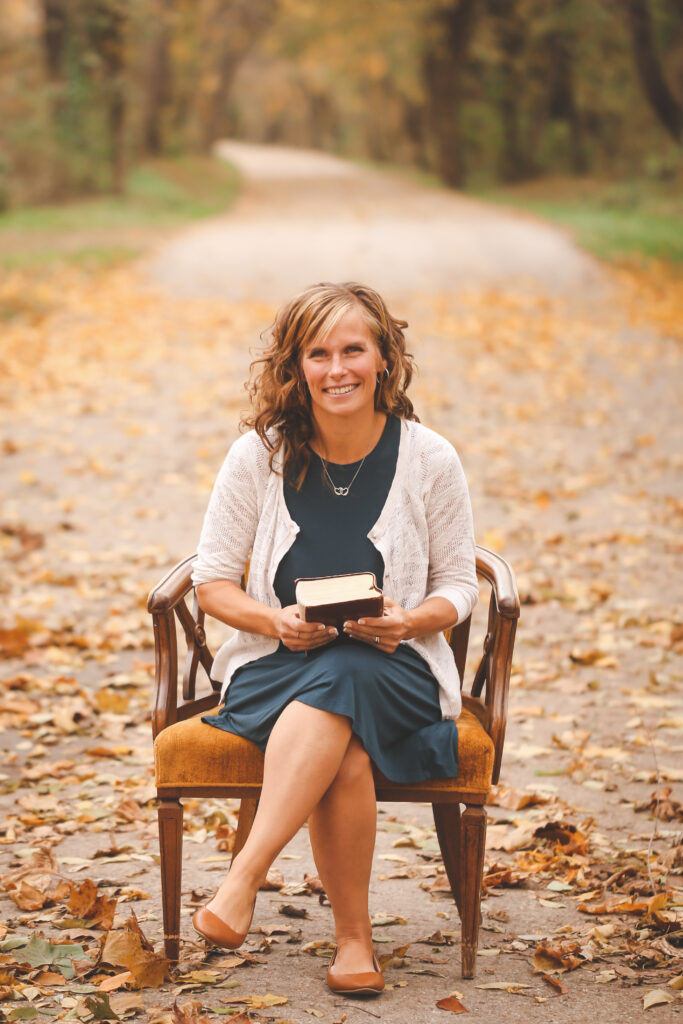 Rachel Risner fall sitting with Bible author about me page photo