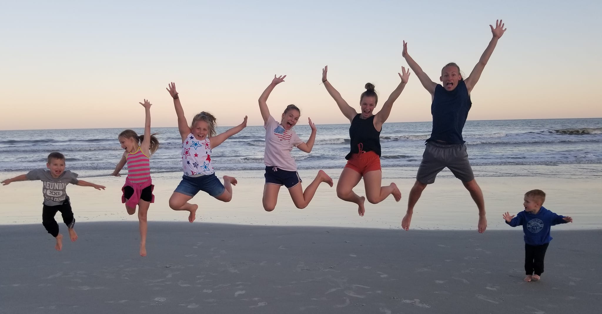 kids jumping on the beach